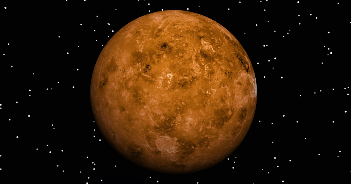 Image of Venus from space, with the full outline of Venus visible, a reddish-brown planet with some darker surface features, on a black backdrop dotted with stars.