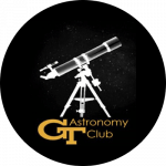 Georgia Tech Astronomy Club logo, a black circle with white outline of a telescope and the words G T Astronomy Club written below in yellow.