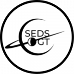 SEDS GT Logo, a white circle with the letters S E D S G T inside of the black outline of a planet with a ring.